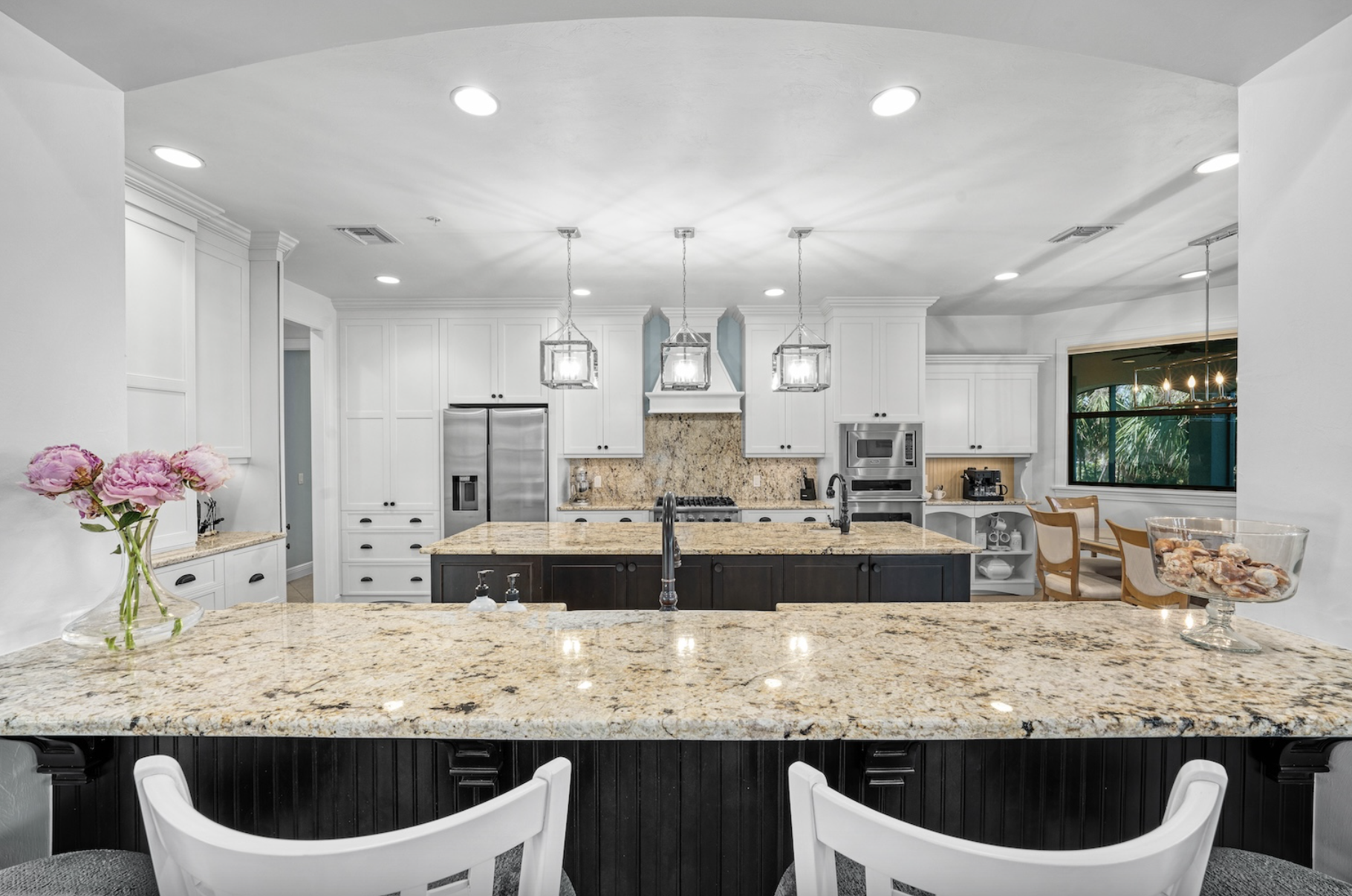 Bright white kitchen at Dockside Dream — coastal cabinetry and Gulf light