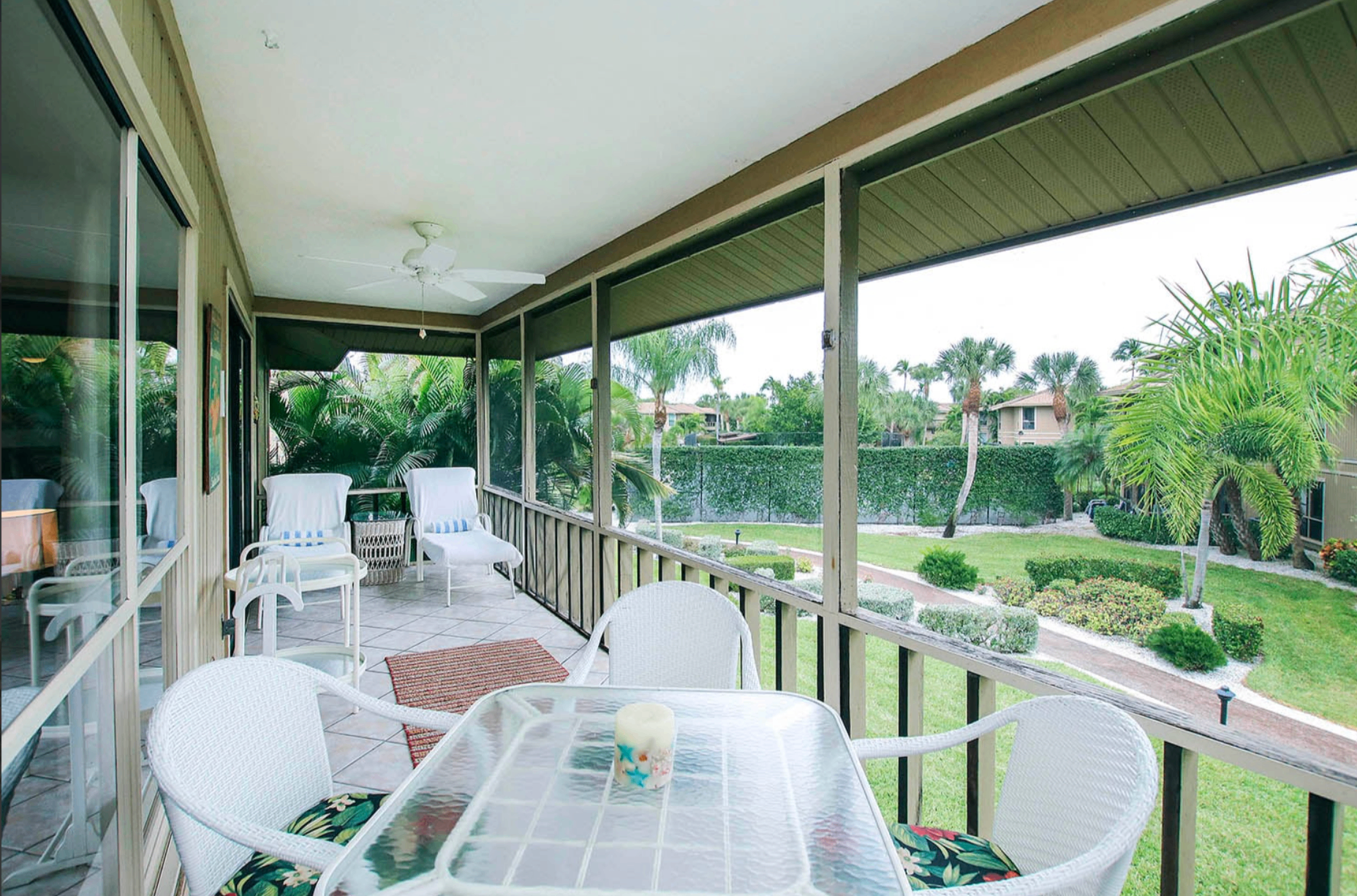 Screened lanai at Blind Pass Beauty overlooking tropical gardens